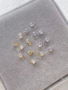 Close-up of gold and silver plated cubic zirconia pendant charms for DIY jewelry making
