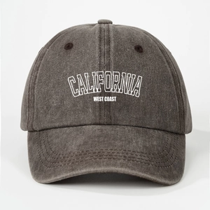 Close-up of washed grey cotton fabric with white California West Coast printed text