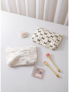 Floral cotton bow cosmetic bags in beige with blue and black patterns for travel