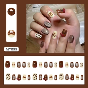 Caramel cat eye press-on nails with 3D bows and leopard patterns in 24 piece set