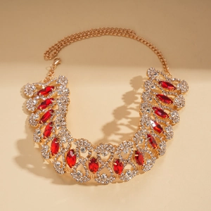 Close-up of elegant court style gold necklace with red marquise and white round rhinestones