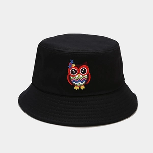 Close-up of colorful cartoon owl embroidery on a black cotton bucket hat with fine stitching