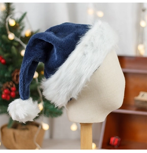 Detail of a navy blue velvet Santa hat with plush white trim on a display mannequin