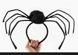 Detailed close-up of flexible black plush spider legs and textured body on Halloween headband
