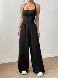 Women's black halter neck wide leg jumpsuit with pleated bodice and cinched waist