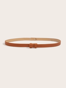 Close-up of a slim brown leather belt with cross-grain texture and matching leather buckle