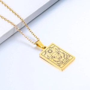 Detailed macro shot of a gold Taurus zodiac rectangle pendant with celestial engravings