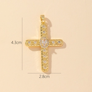 Macro shot of gold cross pendant with clear cubic zirconia showing 4.3cm by 2.8cm size