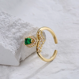 Gold plated adjustable ring featuring a pear-cut emerald green stone and zircon accents