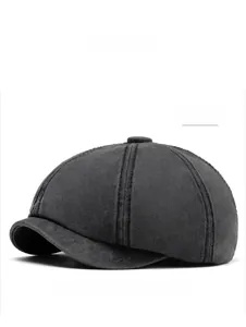 Detailed view of black washed cotton newsboy hat texture and high-quality stitching