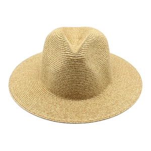 Macro view of hand-woven natural straw panama hat showing detailed texture and tight weave