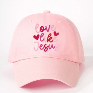 Pink baseball cap featuring Love Like Jesus printed text with artistic heart patterns