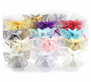 Macro detail of laser cut butterfly candy boxes with satin ribbons in various colors