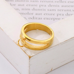 Detailed close-up of a double-layered hollow gold steel ring with a small round charm loop