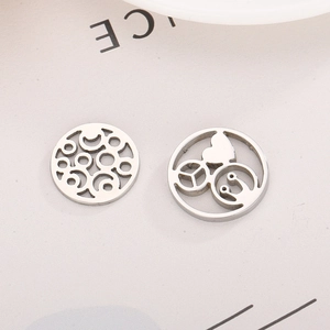 Two circular stainless steel charms with hollow heart and ring patterns for DIY necklaces