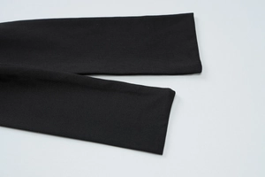 Detailed close-up of high-quality black knitted fabric showing texture and sharp weave detail
