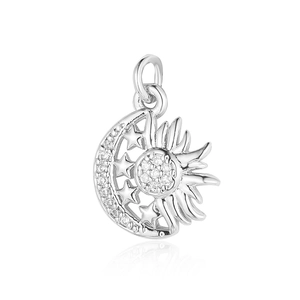Macro shot of silver sun moon star pendant with sparkling cubic zirconia on white base