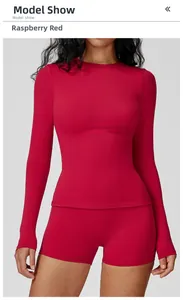 Detailed view of raspberry red brushed long sleeve yoga top and matching shorts set