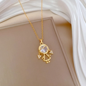 Macro shot of gold necklace featuring a luxury girl pendant with sparkling crystals