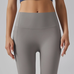 Detail of high waisted seamless yoga leggings with side pocket and matte fabric texture