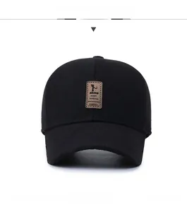 Detailed front view of a black wool baseball cap with a brown leather logo patch