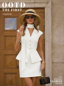Detail of white sleeveless vest and mini skirt set with decorative neck tie