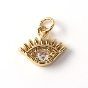 Macro shot of 18k gold plated evil eye charm with sparkling zircon stone for DIY jewelry