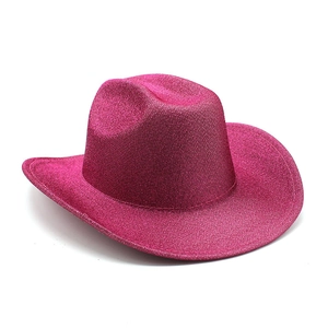 Detail of western cowboy party hat with shiny glitter finish in vibrant hot pink color