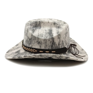 Detail of western cowboy hat featuring tie-dye denim texture and leather band with stitching