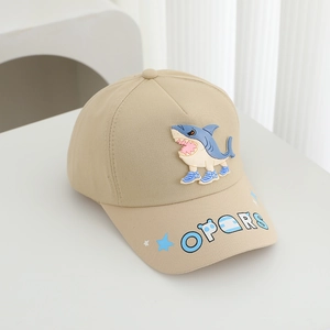 Detail of shark applique and blue star embroidery on khaki kids baseball cap