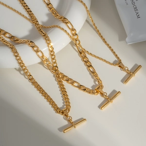 Three gold stainless steel Cuban necklaces with T-bar pendants and flat link chains