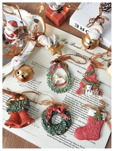 Detailed flat lay of vintage resin Christmas ornaments with silk ribbons on music sheet