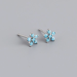 Detail view of flower-shaped S925 sterling silver earrings with turquoise zircon stones