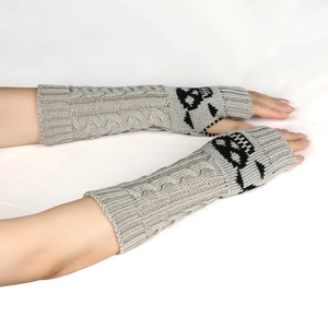 Detail of grey knitted arm warmers with black skull pattern and fingerless design