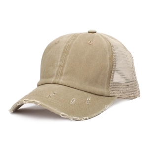Macro detail of khaki washed cotton fabric and breathable mesh on vintage ponytail cap