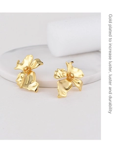 Detail of gold plated flower earrings showing the polished finish and durable texture