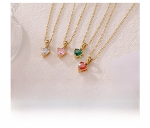Detailed view of four titanium steel heart necklaces with colorful zircon pendants