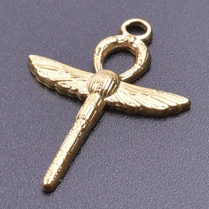 Close-up of golden Egyptian Ankh cross pendant with winged texture on dark background
