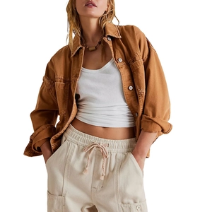 Detail of caramel brown canvas workwear jacket featuring metallic buttons and retro texture