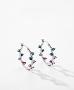 Macro shot of S925 sterling silver hoop earrings with vibrant multi-colored gemstones