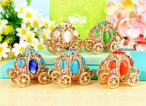 Detail of five rhinestone pumpkin carriage keychains in various vibrant jewel colors