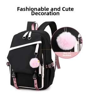 Detail of black and pink backpack with plush ball charm and sporty woven straps