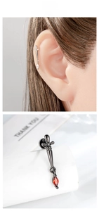 Macro detail of sword-shaped stud earring with micro-pave cubic zirconia inlay