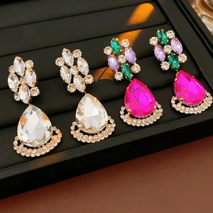 Macro detail of vintage diamond earrings in colorful crystal and teardrop design