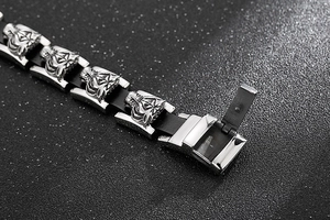 Detail of tiger head bracelet with stainless steel clasp and braided leather band