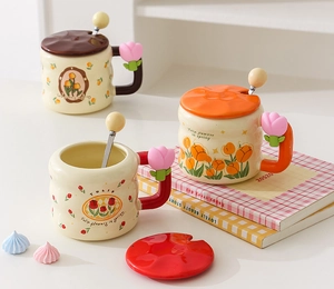 Macro detail of tulip ceramic mugs featuring decorative flower handles and matching lids