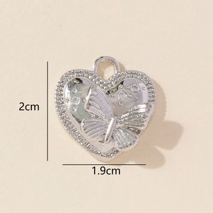 Detail of silver heart pendant with butterfly relief and cubic zirconia stones