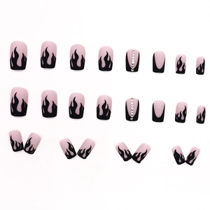 Matte black flame press-on nails with small rhinestones on a nude pink base