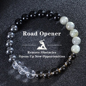Detailed macro view of obsidian and crystal beads with Road Opener spiritual text