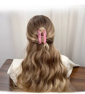 Pink marble acetate hair claw clip styled on a half-up long hairstyle for women